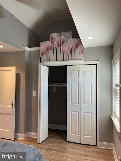 unfurnished bedroom featuring light hardwood / wood-style flooring and a closet