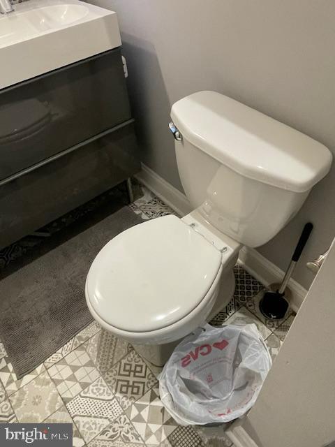 bathroom with toilet, tile patterned flooring, and vanity