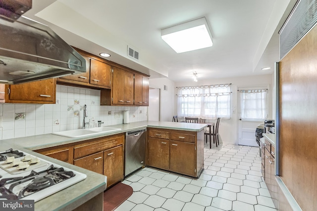 kitchen with dishwasher, kitchen peninsula, sink, white gas cooktop, and ventilation hood