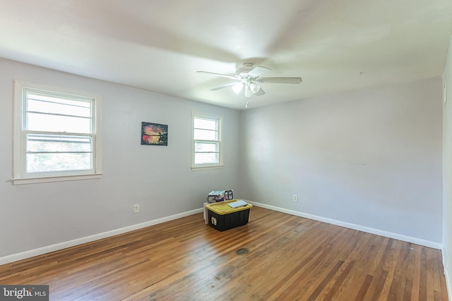 spare room with hardwood / wood-style floors and ceiling fan