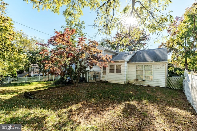 rear view of house with a yard