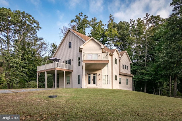 rear view of house featuring a lawn