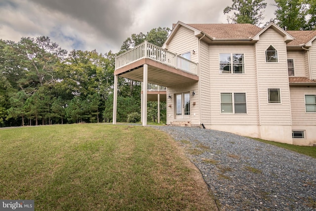 back of house with a yard, a deck, and french doors