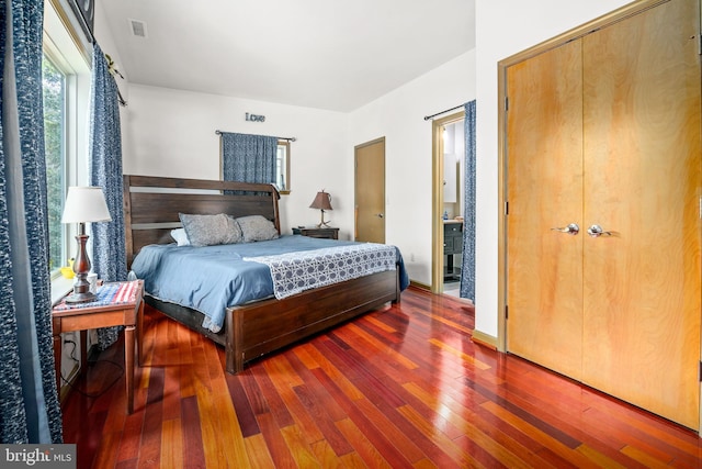 bedroom featuring dark hardwood / wood-style floors and a closet