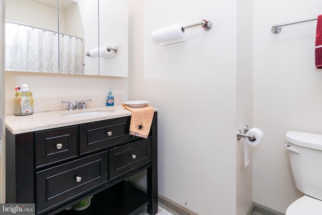 bathroom featuring vanity and toilet