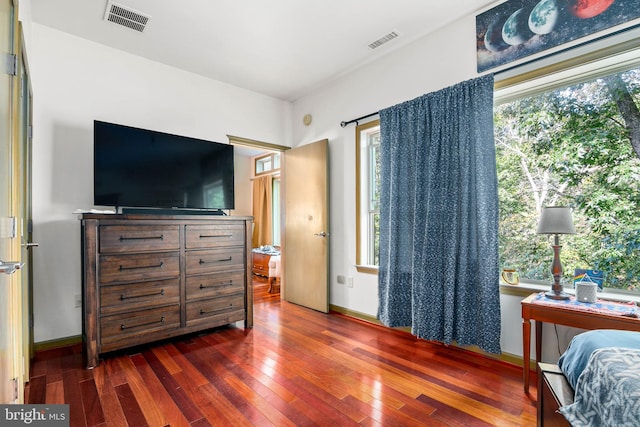 bedroom with dark hardwood / wood-style floors