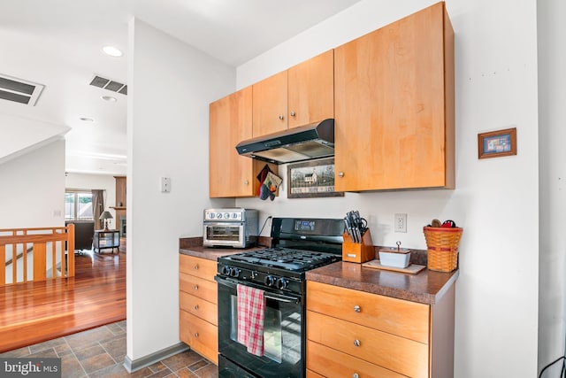 kitchen featuring dark hardwood / wood-style floors and stainless steel gas stove