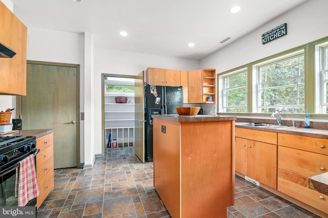 kitchen featuring a center island, black appliances, and sink