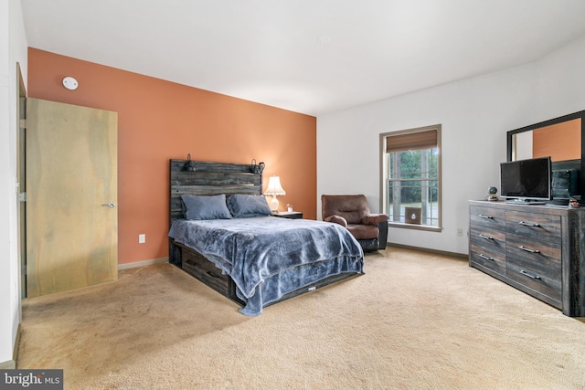 bedroom featuring light colored carpet