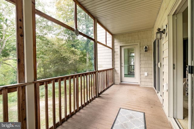 unfurnished sunroom with wooden ceiling