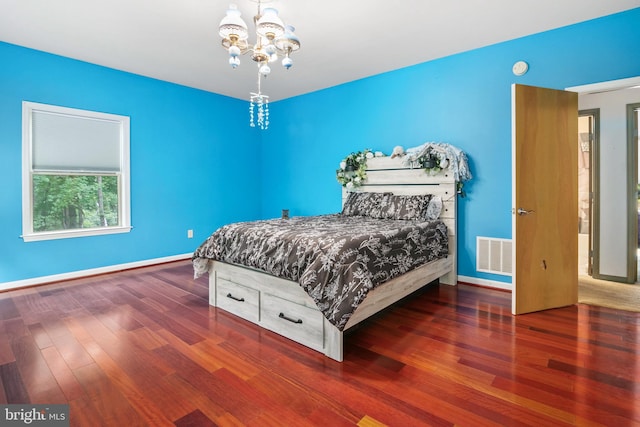 bedroom featuring a chandelier and dark hardwood / wood-style floors