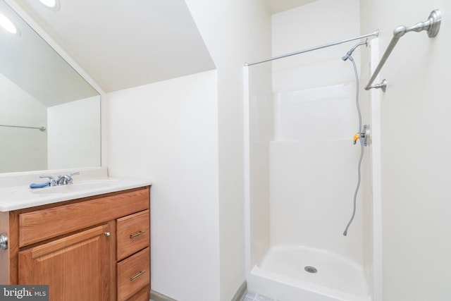 bathroom with vanity and a shower