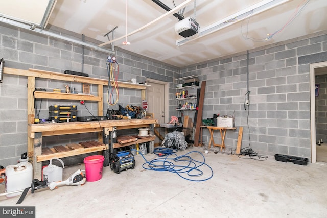 garage with a garage door opener and a workshop area