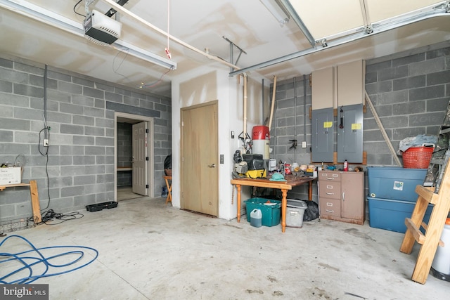 garage featuring a garage door opener, electric panel, and a workshop area