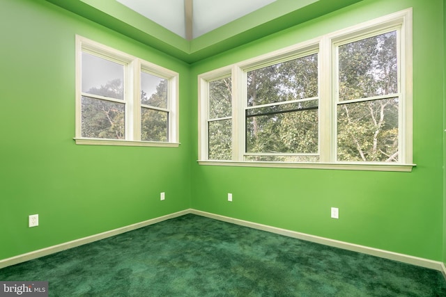 unfurnished room featuring dark colored carpet