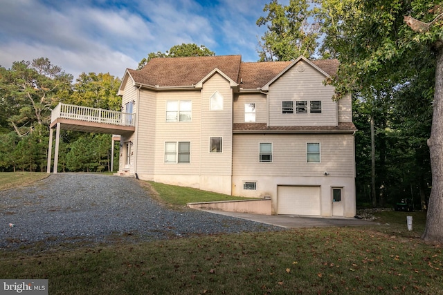 view of property exterior featuring a wooden deck and a garage