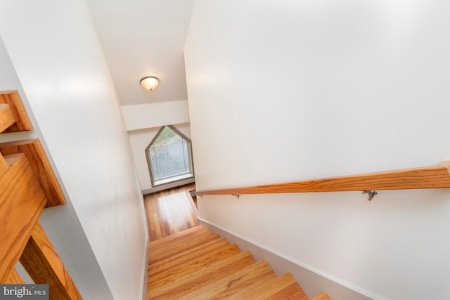 stairs featuring hardwood / wood-style floors