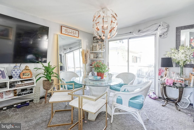 carpeted dining area featuring a notable chandelier