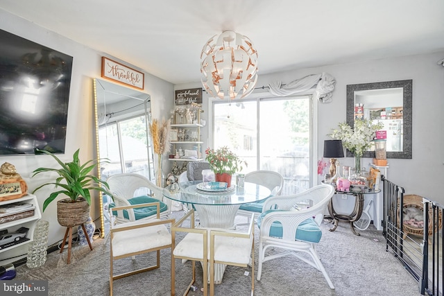 dining room featuring carpet flooring and an inviting chandelier