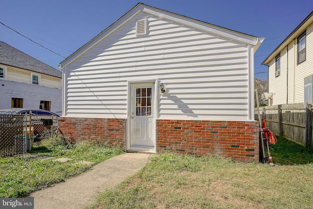view of outbuilding with fence