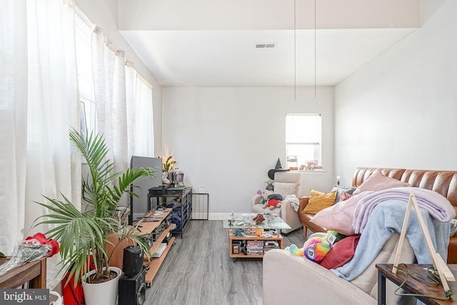 living room featuring visible vents and wood finished floors