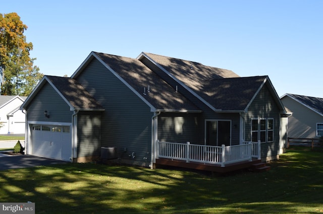 exterior space featuring a garage and a lawn