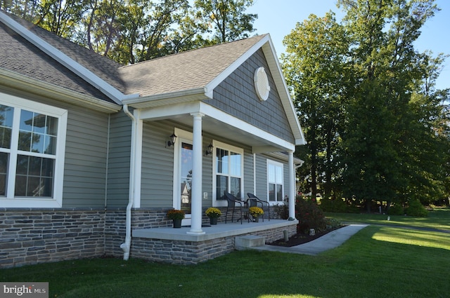 exterior space with a front yard and covered porch