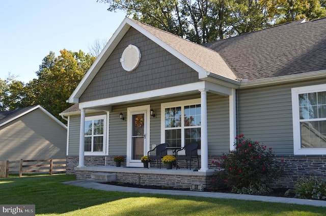 craftsman inspired home featuring a front yard and covered porch