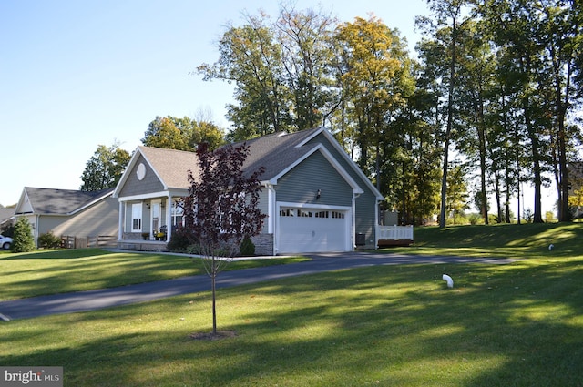 view of front of home with a front yard and a garage