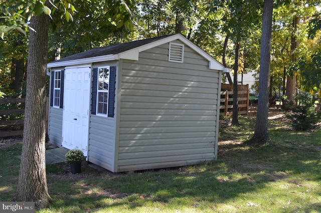 view of outdoor structure featuring a lawn