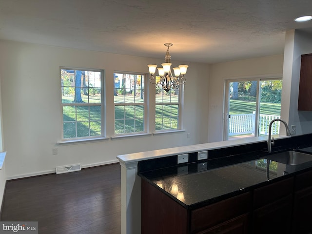 kitchen featuring an inviting chandelier, sink, dark hardwood / wood-style floors, and a healthy amount of sunlight