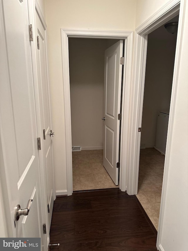 corridor featuring dark wood-type flooring