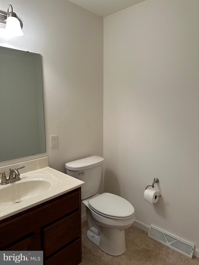 bathroom featuring vanity, toilet, and tile patterned flooring