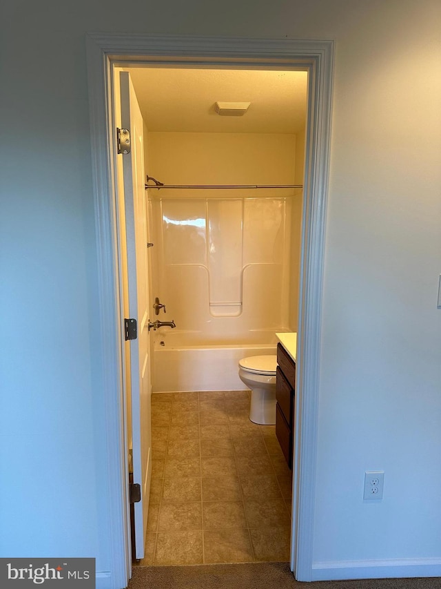 full bathroom featuring vanity, toilet, tile patterned flooring, and shower / bathtub combination