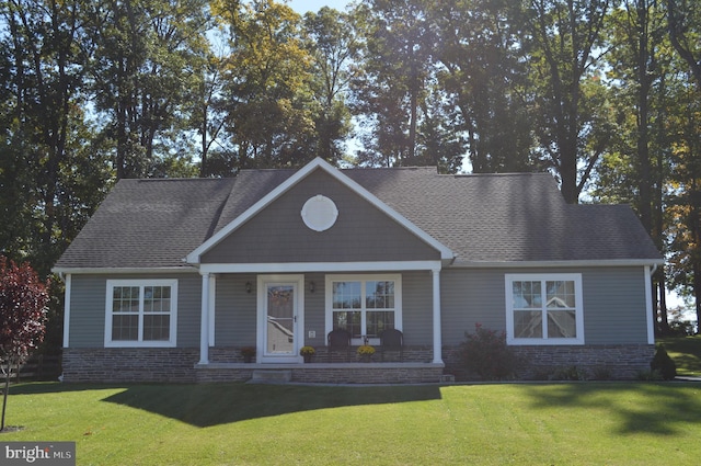 view of front of house featuring covered porch and a front yard