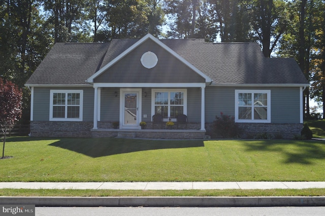 view of front of house featuring a front yard and a porch