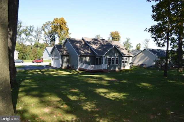 exterior space with a garage and a lawn