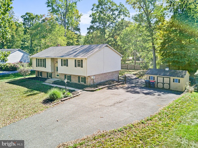 split foyer home with an outbuilding and a front lawn