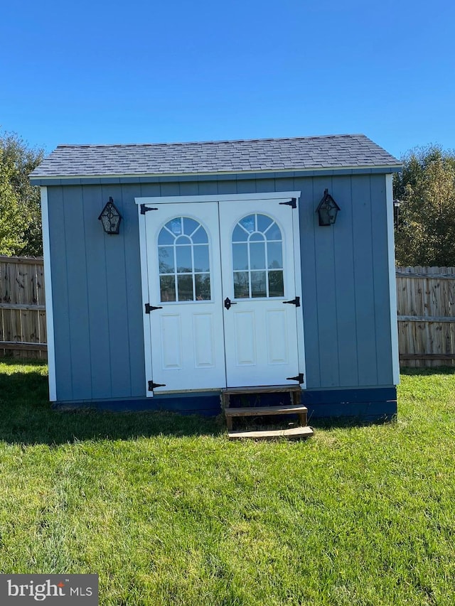 view of outbuilding with a lawn