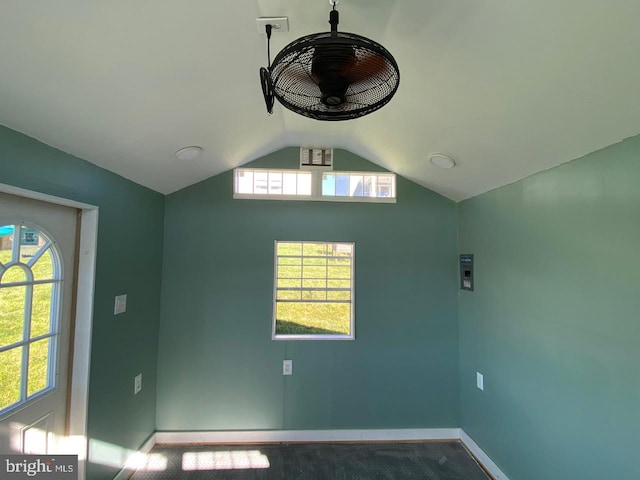 unfurnished room featuring carpet flooring and lofted ceiling