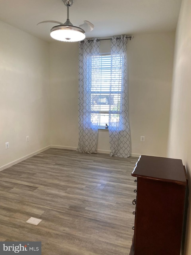 unfurnished room with hardwood / wood-style flooring