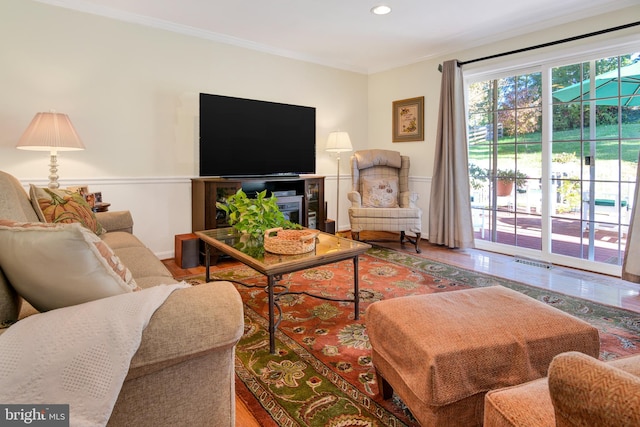 living room featuring hardwood / wood-style floors and ornamental molding