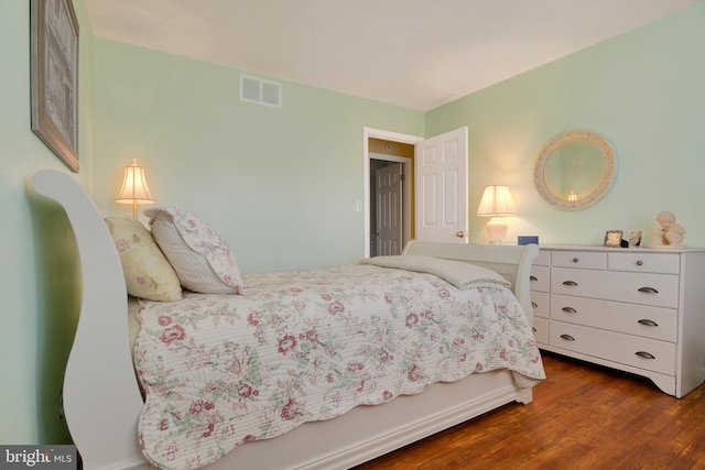 bedroom with dark hardwood / wood-style flooring