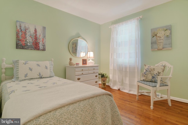 bedroom with wood-type flooring