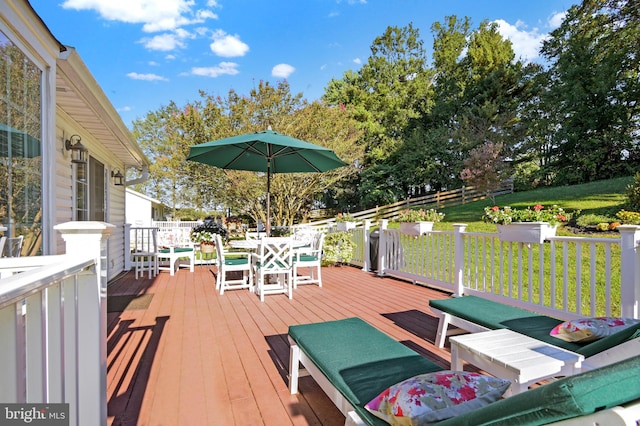 wooden terrace featuring a lawn