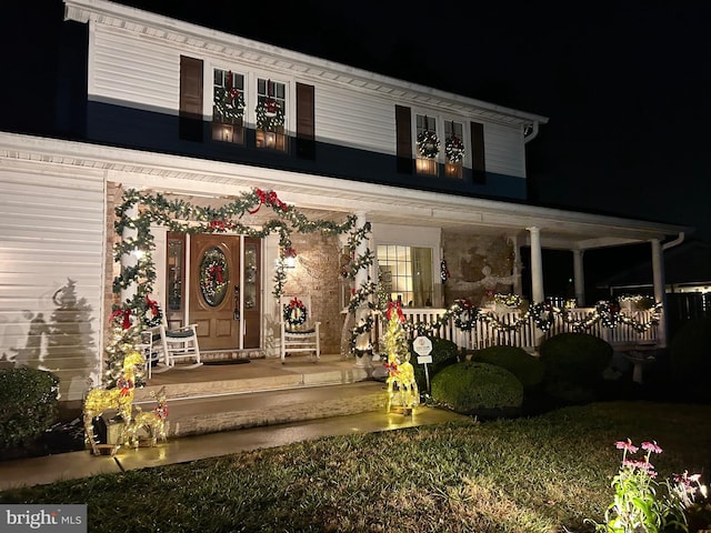 exterior entry at twilight with a porch