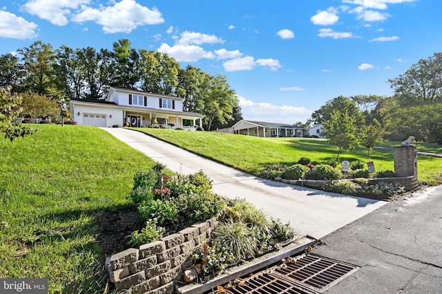 2123 Round Hill Rd, Fallston, MD 21047 - view of front of house with a front lawn, an attached garage, concrete driveway, and covered porch