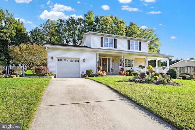 front of property with covered porch, a front yard, and a garage