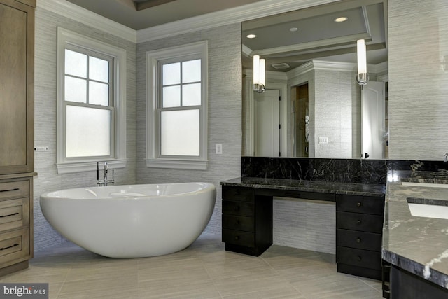 bathroom with vanity, a bathtub, tile patterned floors, tile walls, and crown molding