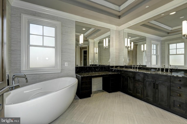 bathroom featuring a tub, crown molding, a tray ceiling, and vanity